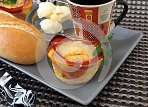 Creative breakfast Ã¢â¬â egg muffins with bacon, coffee, white bread, butter